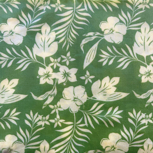 Floral pattern with white flowers and leaves on a green beeswax wrap