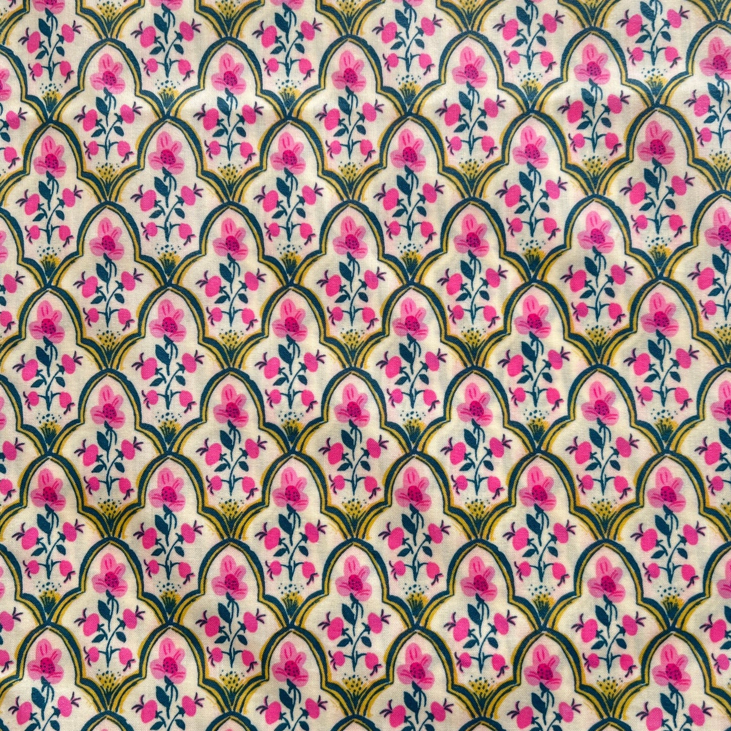 Decorative fabric pattern with pink flowers and green leaves on a white beeswax wrap