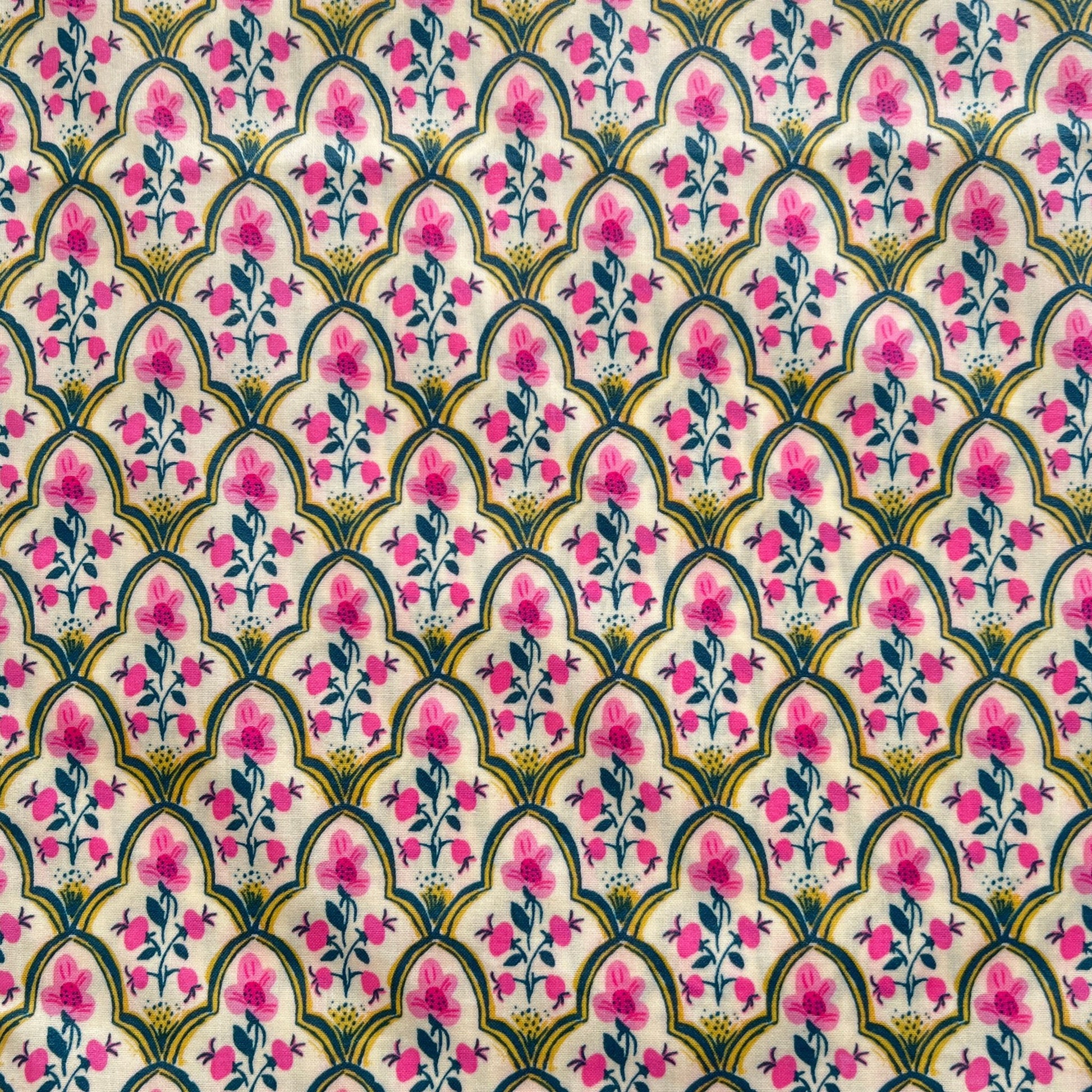 Decorative fabric pattern with pink flowers and green leaves on a white beeswax wrap