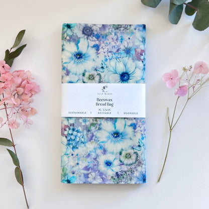 Floral blue patterned beeswax bread bag with flowers and baguette bread.