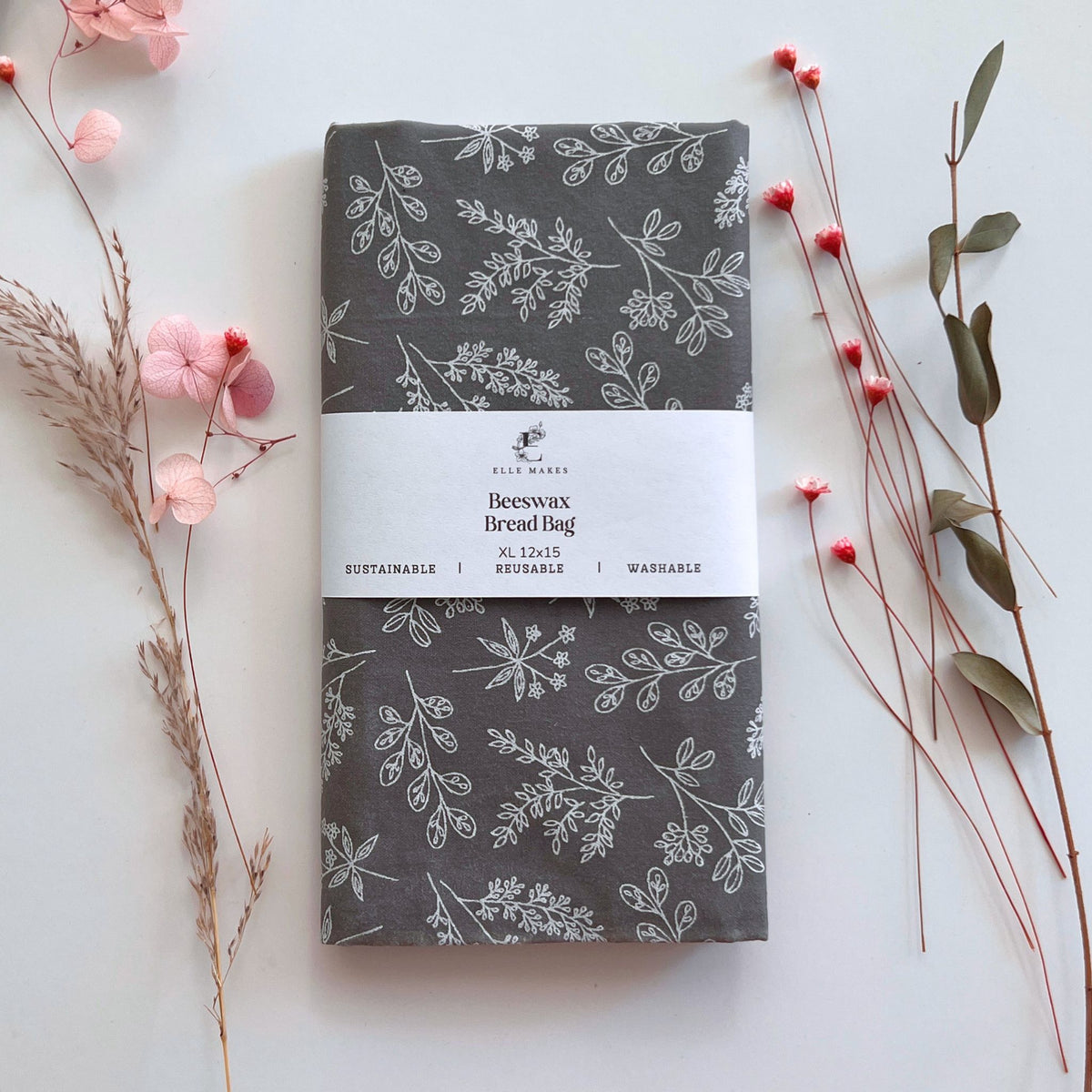Beeswax bread bag with floral leafy pattern on a white background with flowers and leaves.