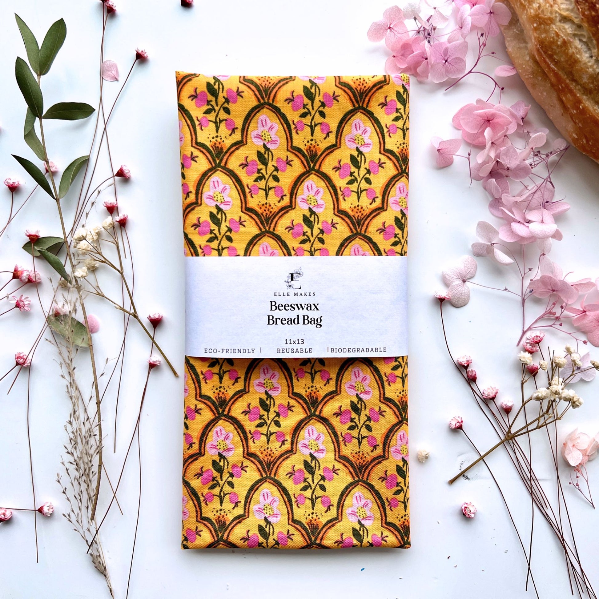 Orange beeswax bread bag with simple pink floral design.