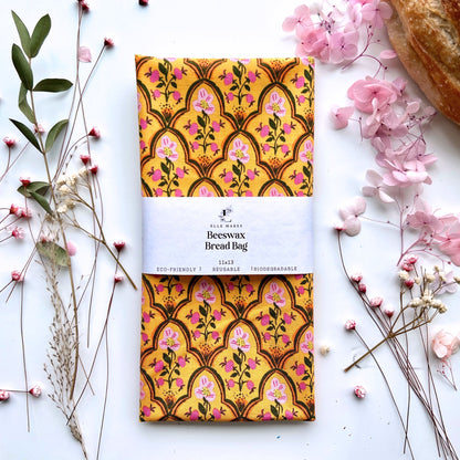 Orange beeswax bread bag with simple pink floral design.