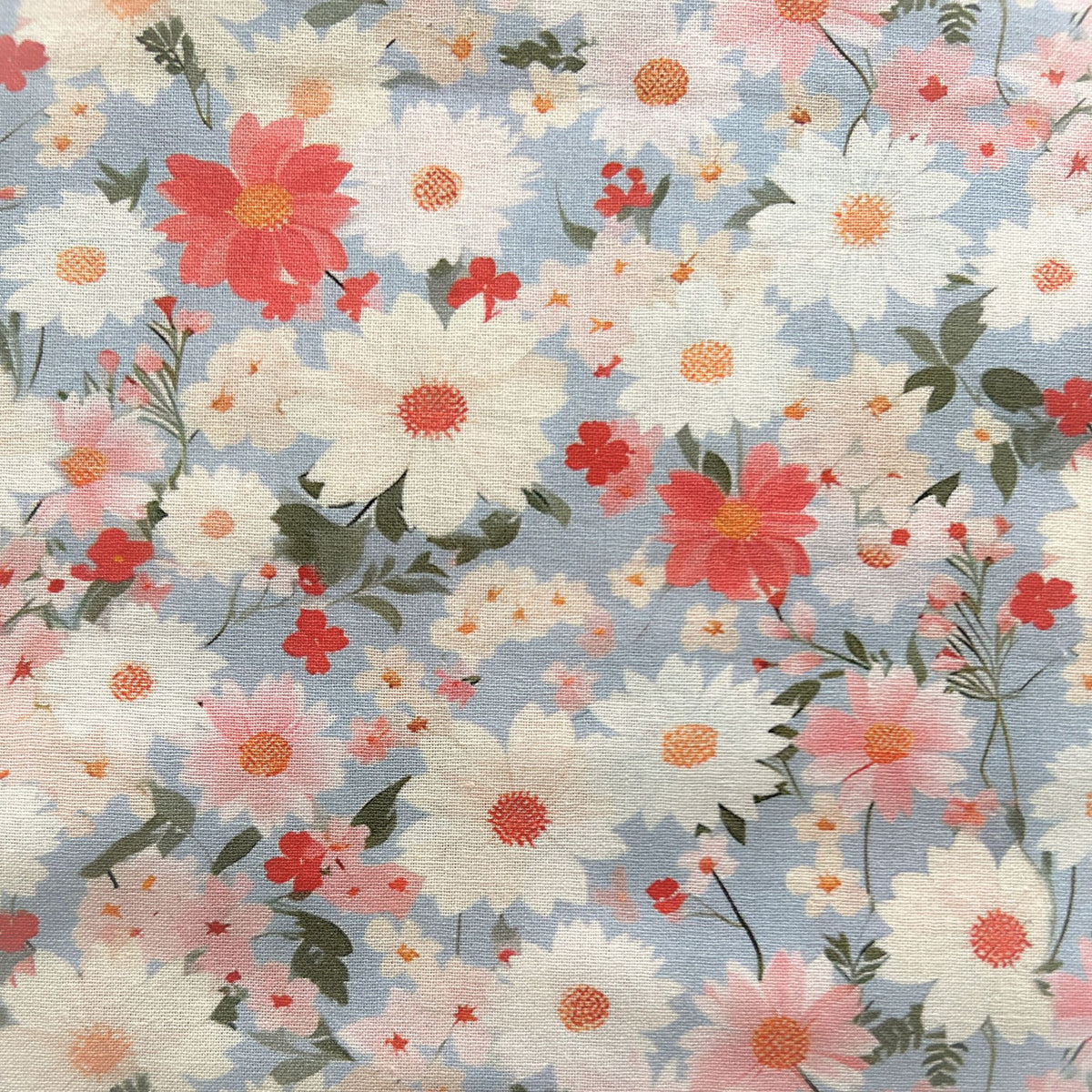 Floral pattern with pink, white, and red flowers on a light blue reusable beeswax food wrap