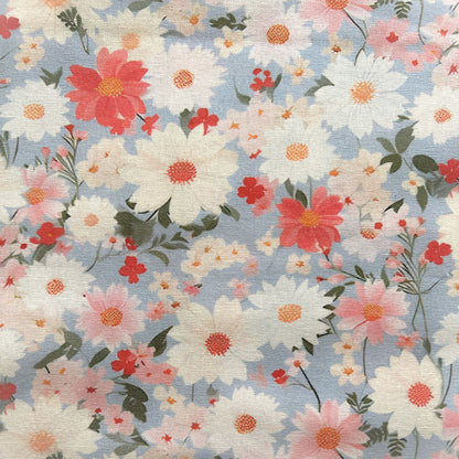 Floral pattern with pink, white, and red flowers on a light blue reusable beeswax food wrap
