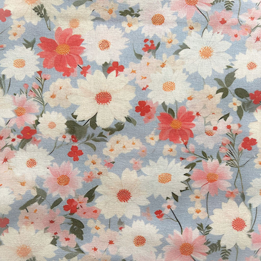 Floral pattern with pink, white, and red flowers on a light blue reusable beeswax food wrap
