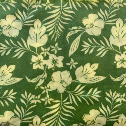 Floral pattern with white flowers and leaves on a green beeswax wrap