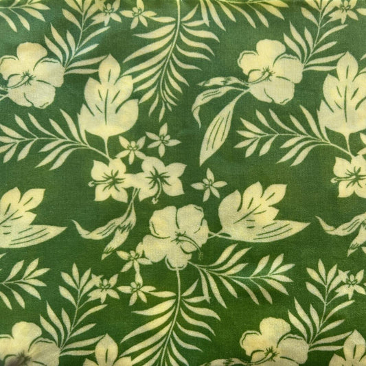 Floral pattern with white flowers and leaves on a green beeswax wrap