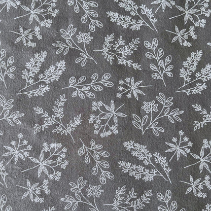 White floral pattern on a gray reusable beeswax food wrap