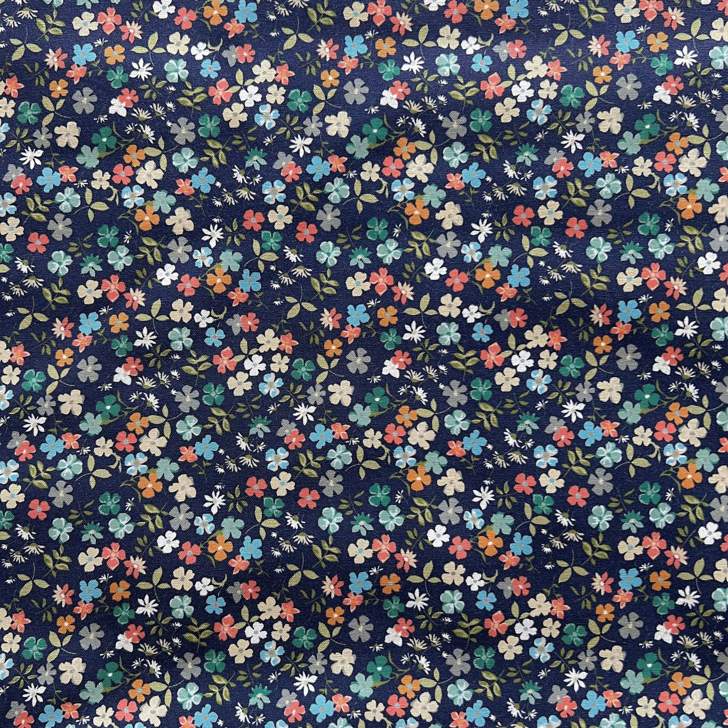 Navy blue beeswax food wrap with small multicolored floral pattern