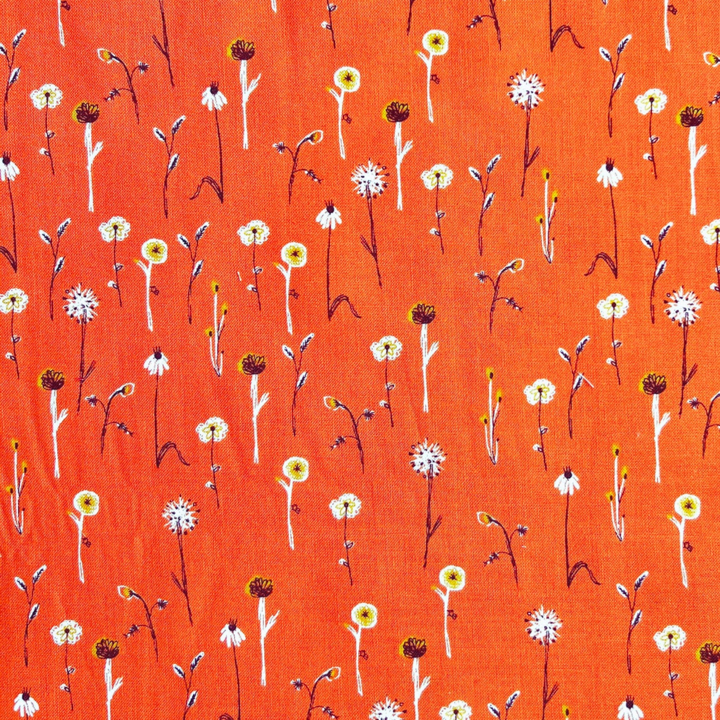 simple white floral pattern on an orange beeswax wrap