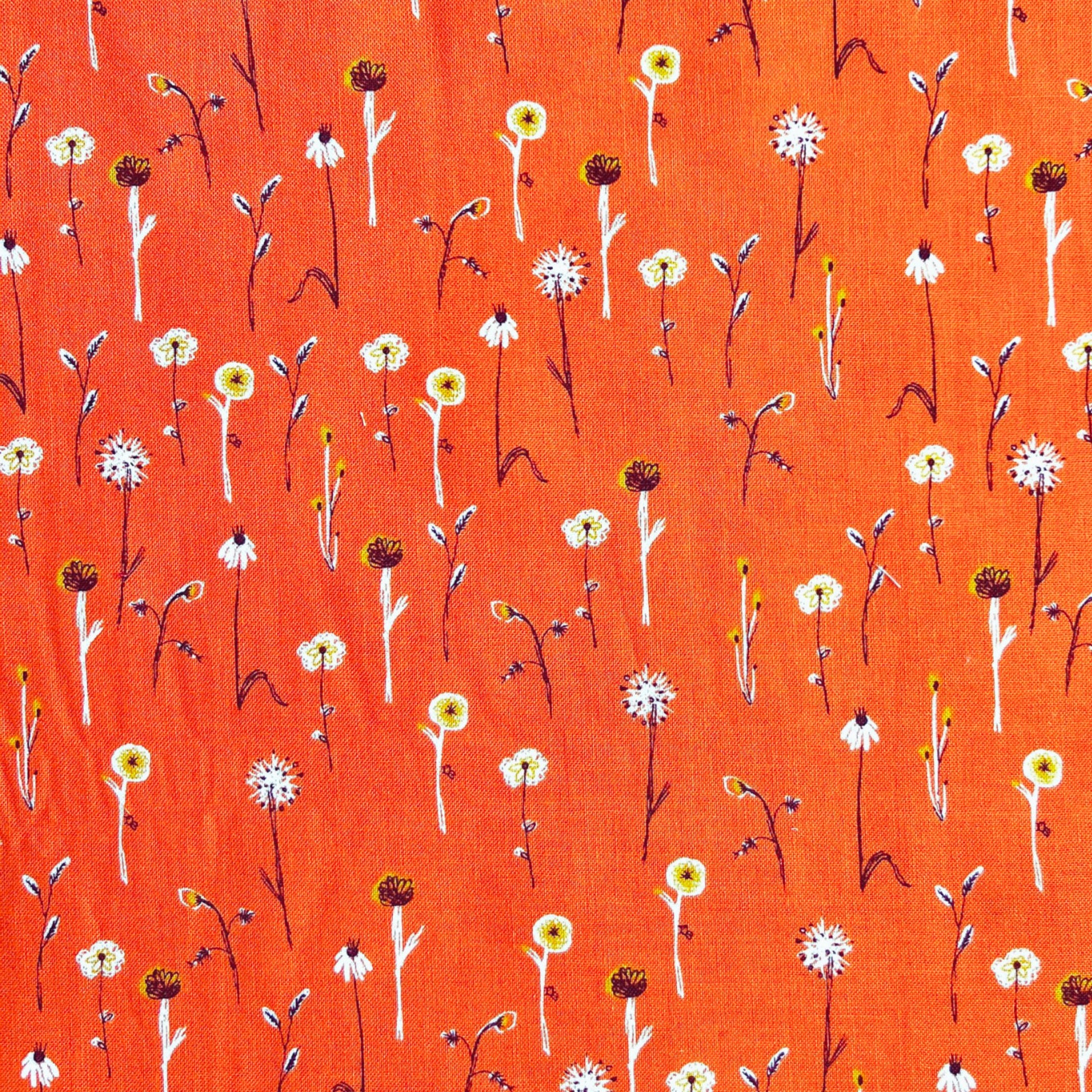 simple white floral pattern on an orange beeswax wrap