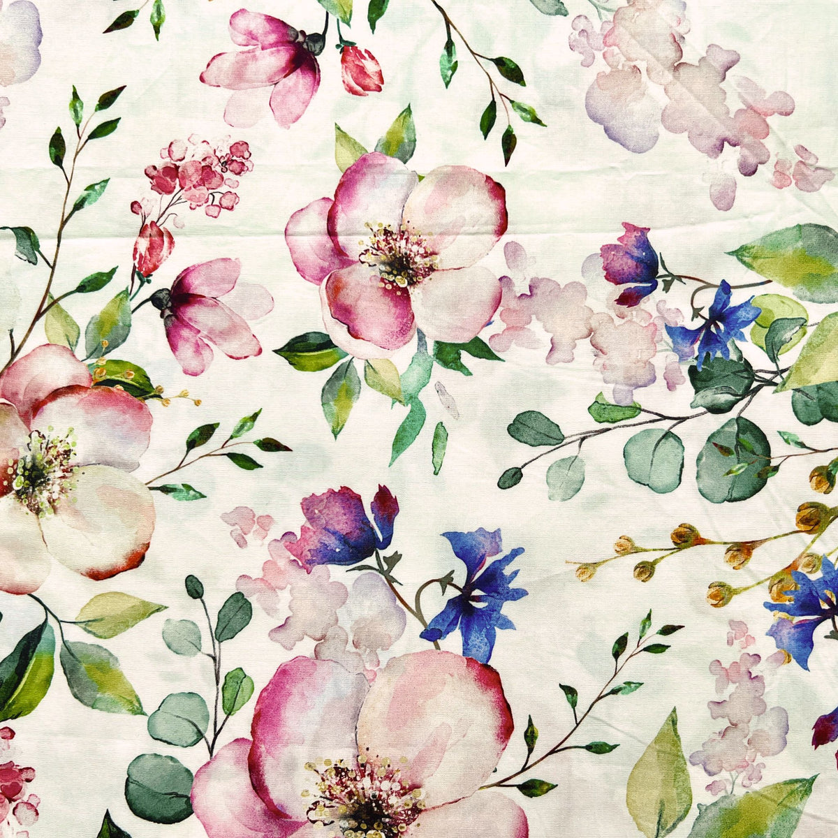 Floral pattern with pink, purple, and green flowers on a white reusable beeswax food wrap