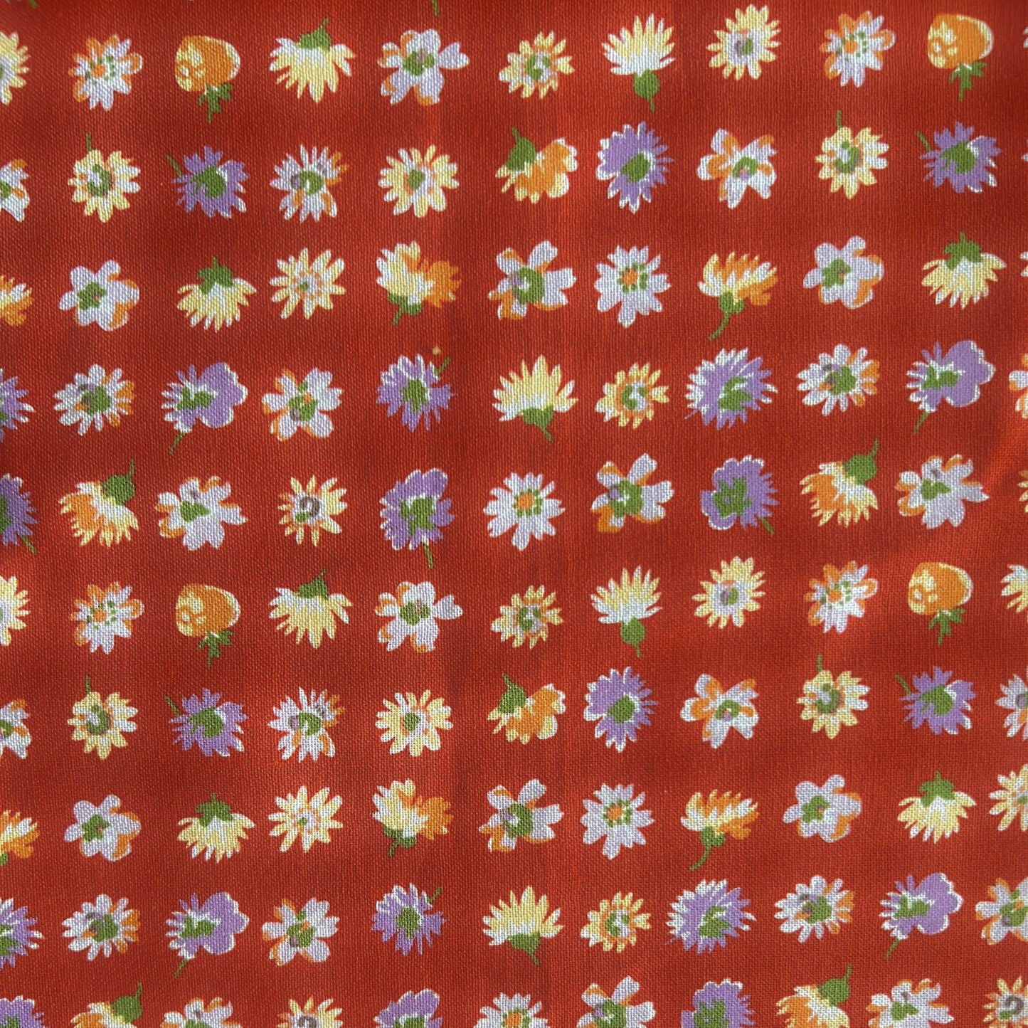 Pattern of colorful flowers on a red reusable beeswax food wrap