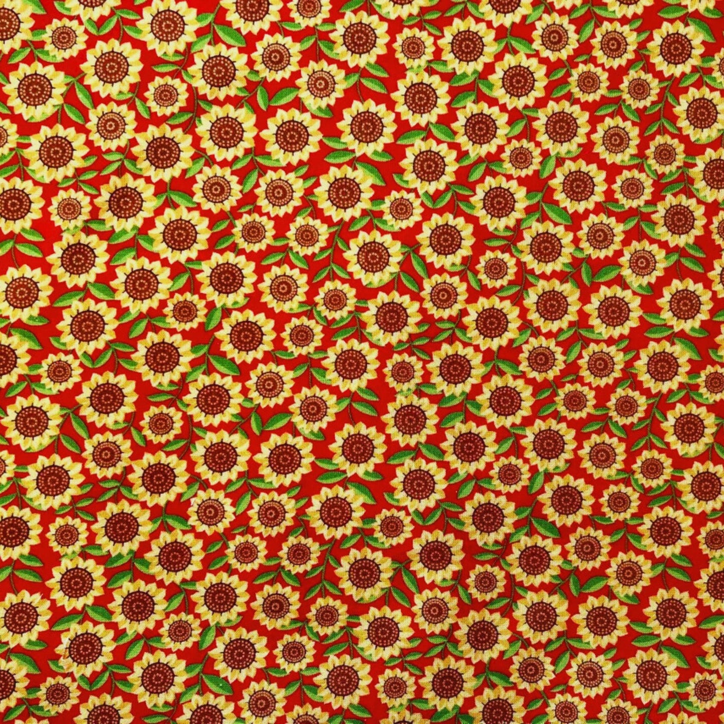 Pattern of bright yellow sunflowers with a red background on a beeswax wrap