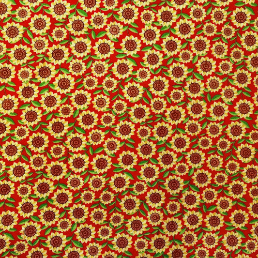 Pattern of bright yellow sunflowers with a red background on a beeswax wrap