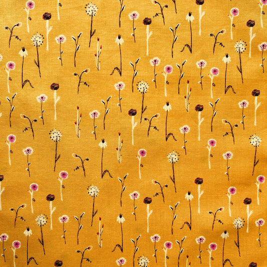Floral pattern with small white flowers on a yellow beeswax wrap